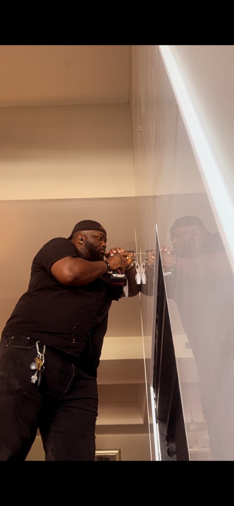 Technician installing wall fixture